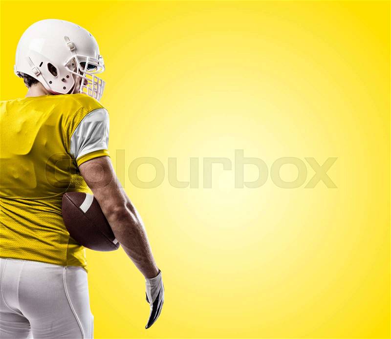 Football Player with a yellow uniform on a yellow background, stock photo