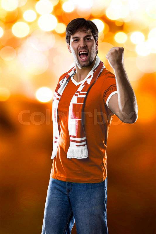 Dutch Fan Celebrating, on a orange lights background, stock photo