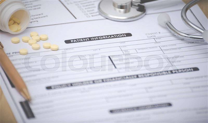 Close-up of patient information concept,Stetoscope and medicine,pen on patient form on the desk, stock photo