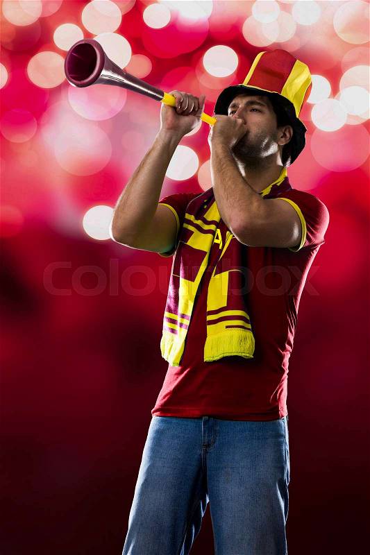 Spanish Fan Celebrating, on a Red lights background, stock photo