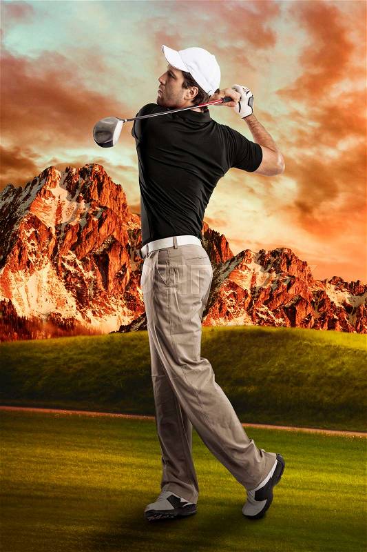 Golf Player in a black shirt taking a swing, on a golf course, stock photo