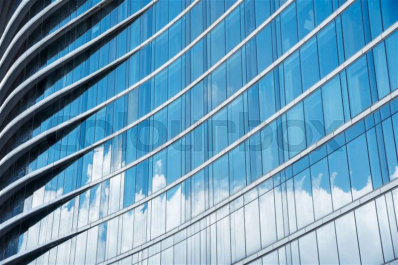 Pattern of blue glasses in high building with shadow of cloud. Abstract modern building background, stock photo