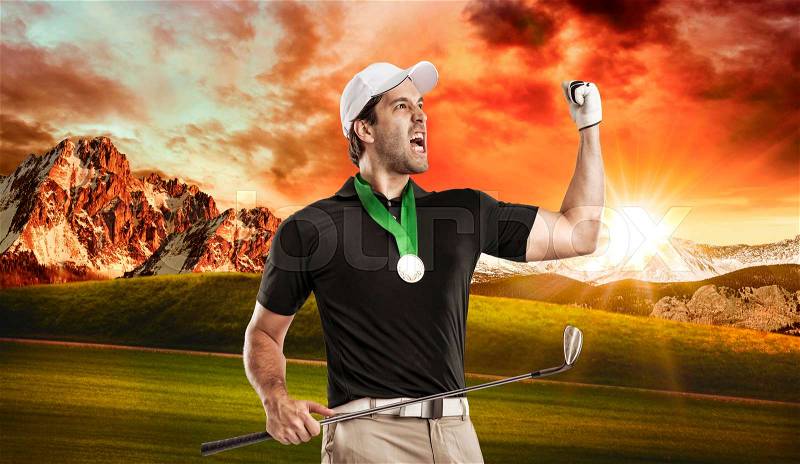 Golf Player in a black shirt celebrating with a golden medal, on a golf course, stock photo