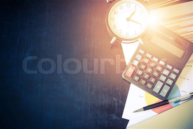 Business chart analysis report with pen, calculator and alarm clock on office table. Business background concept. Soft light and vintage filtered, stock photo
