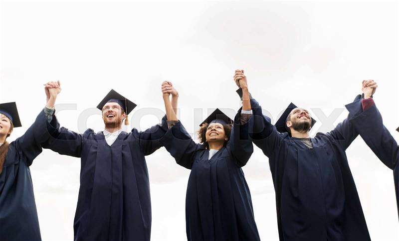 Education, graduation and people concept - group of happy international students in mortar boards and bachelor gowns celebrating success, stock photo