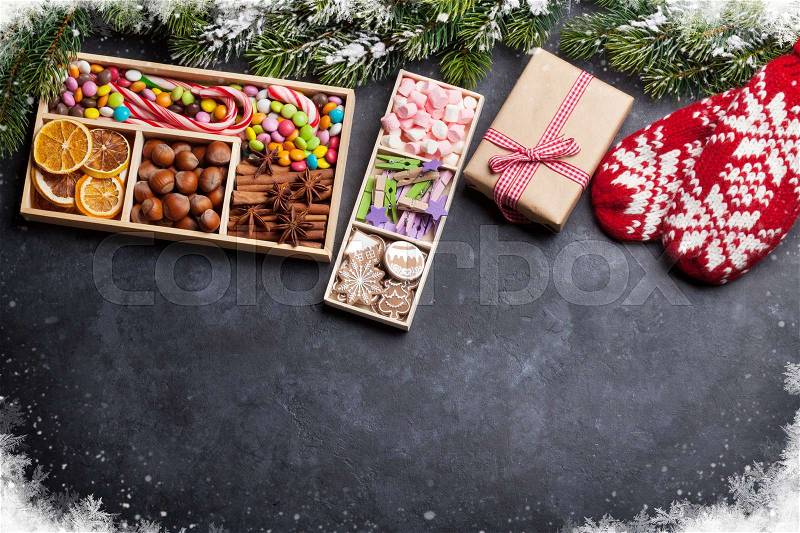 Christmas gift box and food decor on stone table with fir tree. Top view with copy space, stock photo