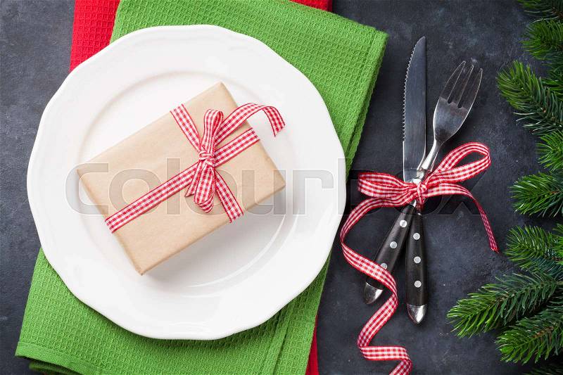 Christmas gift box dinner plate, silverware, fir tree. Top view, stock photo
