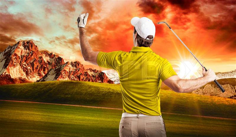 Golf Player in a yellow shirt celebrating, on a golf course, stock photo