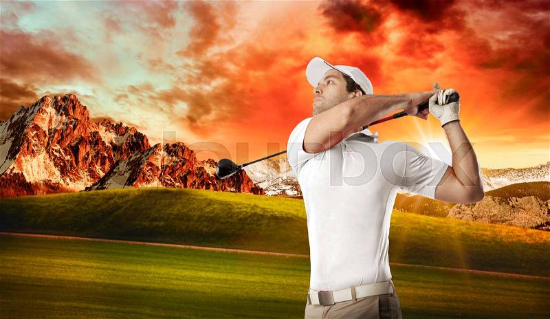 Golf Player in a white shirt taking a swing, on a golf course, stock photo