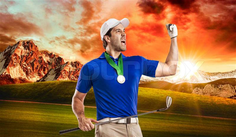 Golf Player in a blue shirt celebrating with a golden medal, on a golf course, stock photo