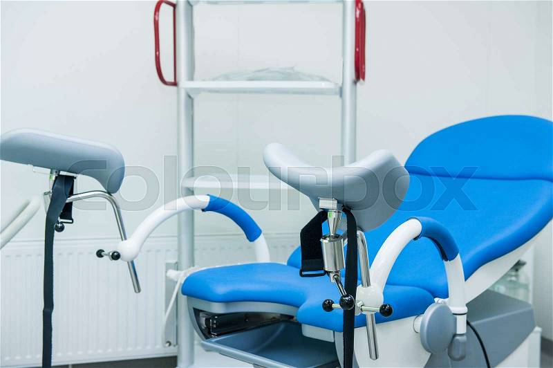 Gynecological surgery room with chair and equipment, stock photo