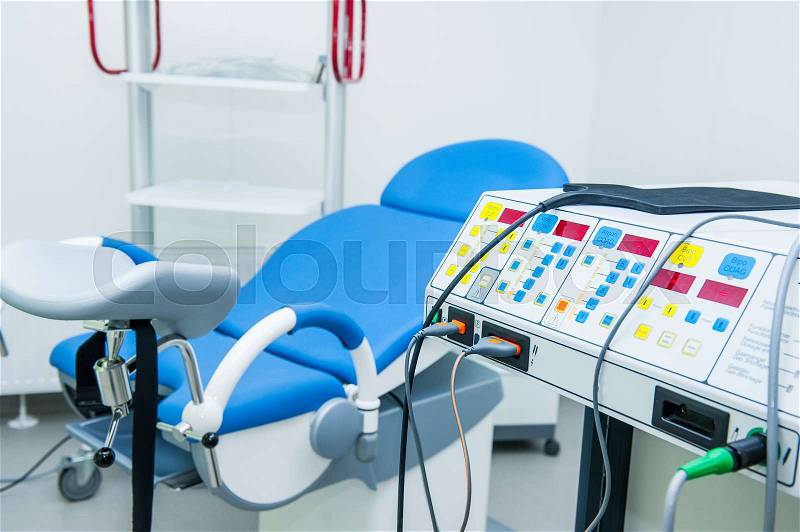 Gynecological surgery room with chair and equipment, stock photo