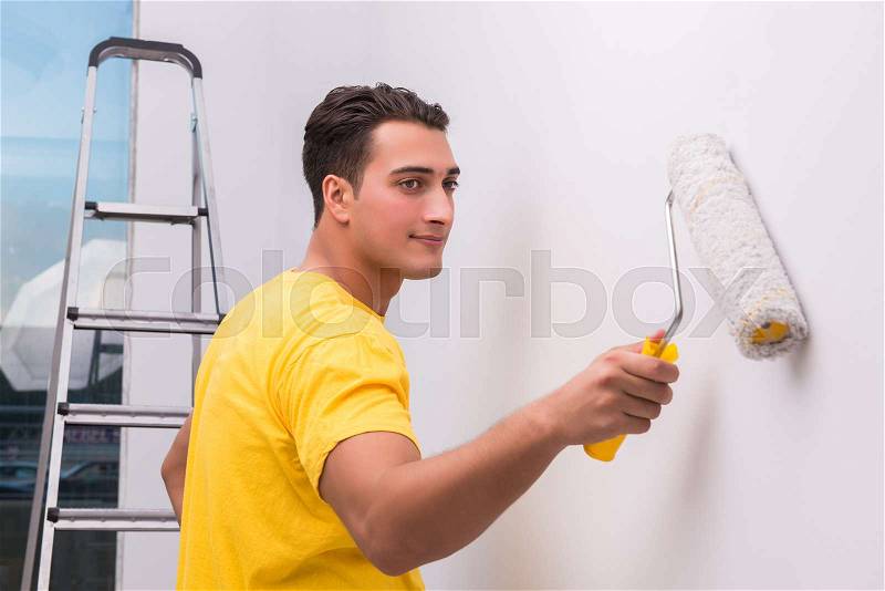 Man painting house in DIY concept, stock photo