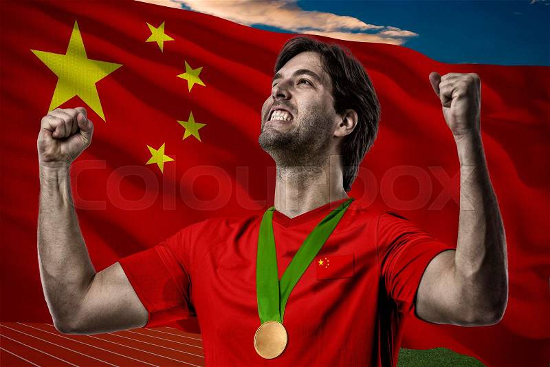 Chinese Athlete Winning a golden medal in front of a Chinese flag, stock photo