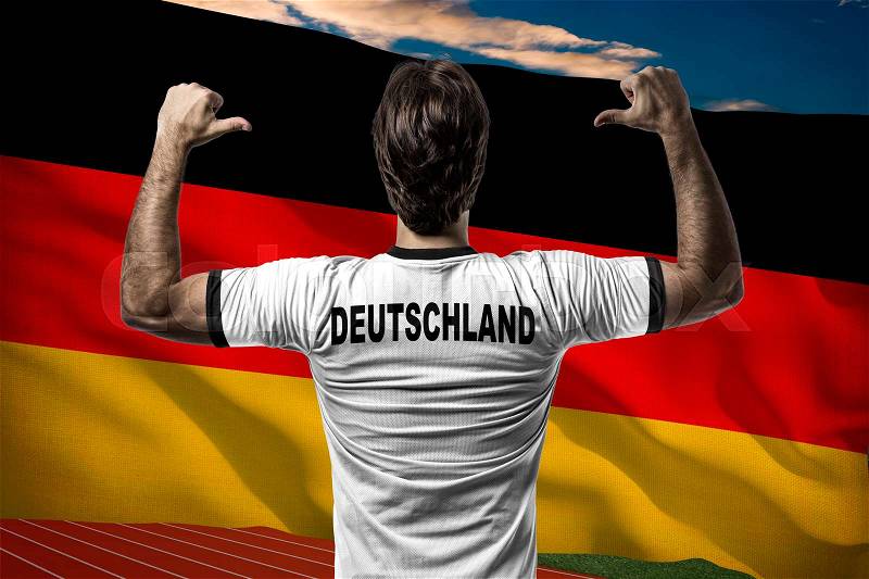 German Athlete Winning a golden medal in front of a German flag, stock photo