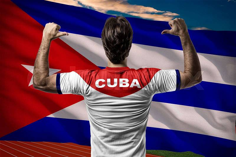 Cuban Athlete Winning a golden medal in front of a cuban flag, stock photo