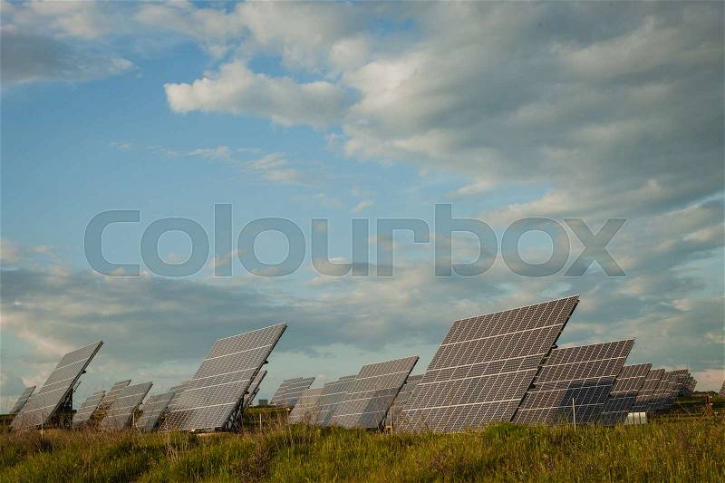 Solar panels in the landscape with a cloudy sky of background, stock photo