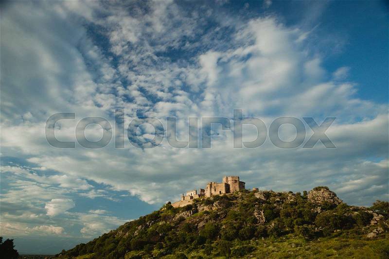 Beautiful Spanish old castle over a hill with a amazing sky of background, stock photo