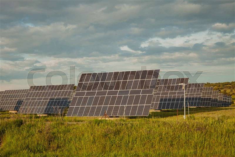 Solar panels in the landscape with a cloudy sky of background, stock photo