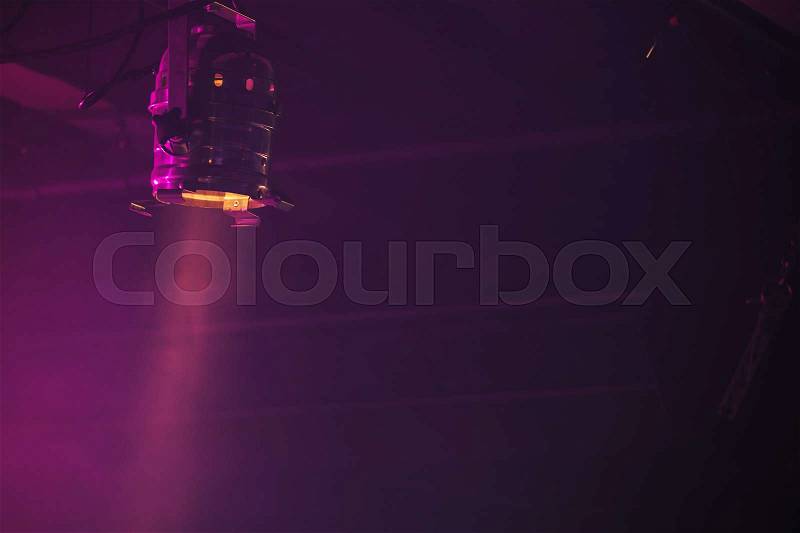 Scenic spot light beam over dark purple background, stage illumination equipment, stock photo