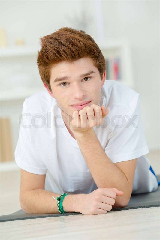 Teenager about to do some push-ups, stock photo