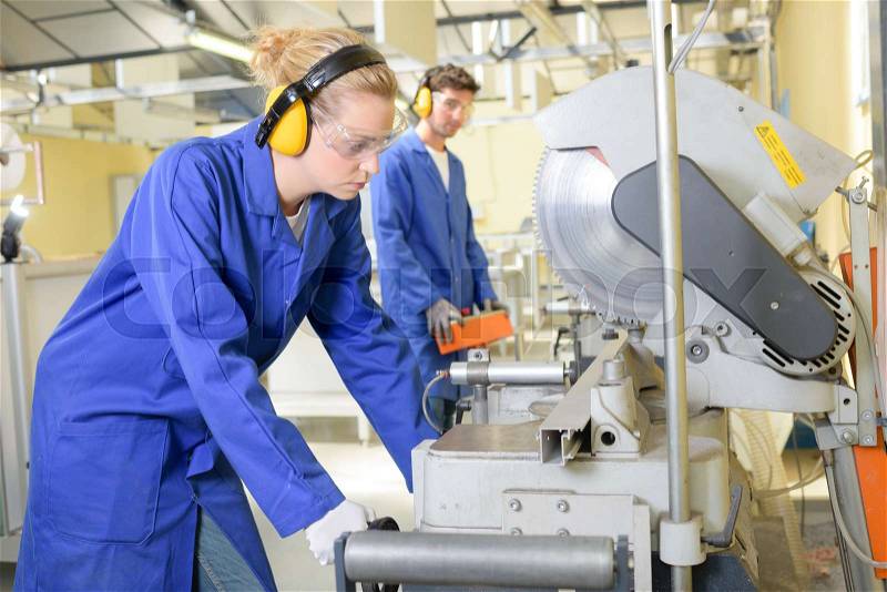 Young qualified people forced to work at the factory, stock photo