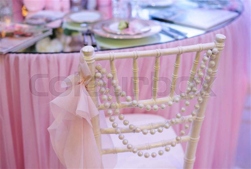 White wedding decor Chair near table in a restaurant, stock photo