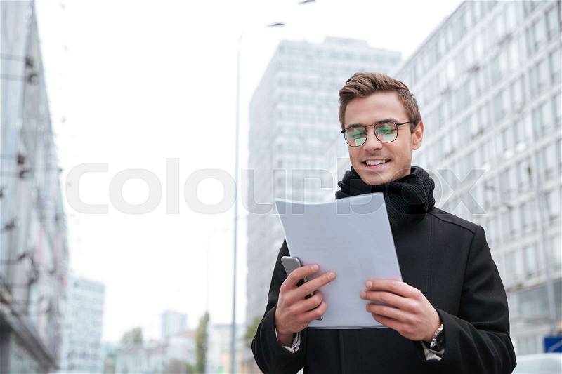 Business man with documents on the street. from below, stock photo