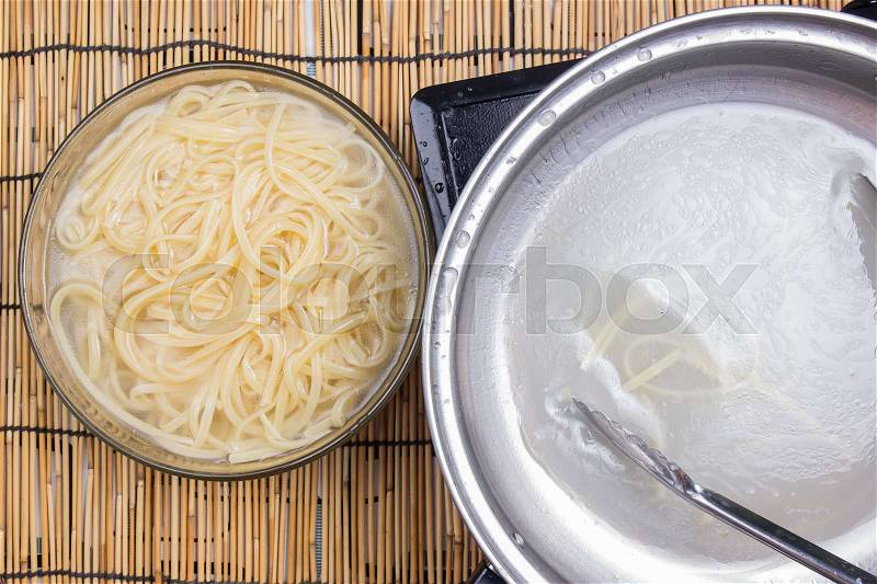 Spaghetti lifted on of cold water with tomgs / cooking spicy spaghetti concept, stock photo