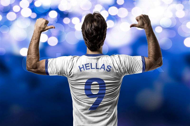 Greek soccer player, celebrating on a blue lights background, stock photo