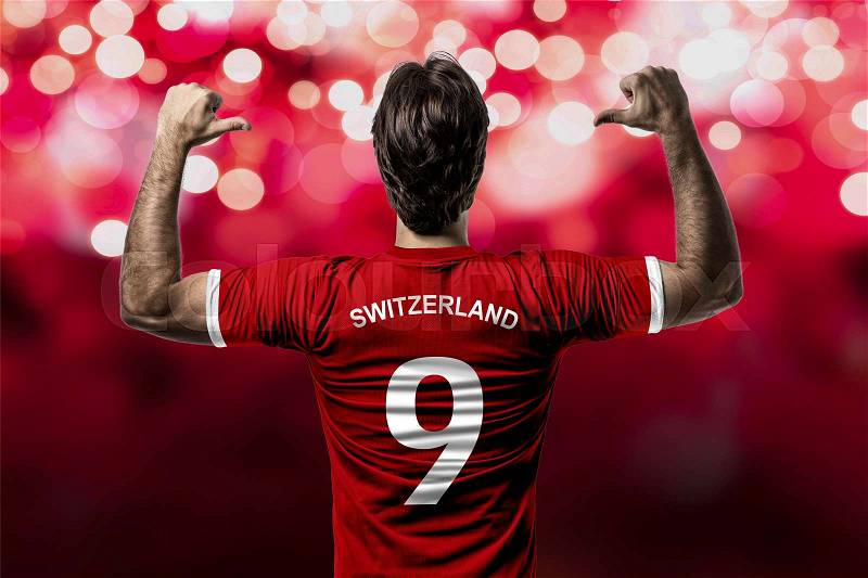 Swiss soccer player, celebrating on a red lights background, stock photo