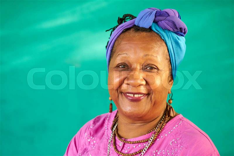 Old Cuban people and emotions, portrait of senior african american lady laughing and looking at camera. Happy elderly black woman from Havana, Cuba smiling, stock photo