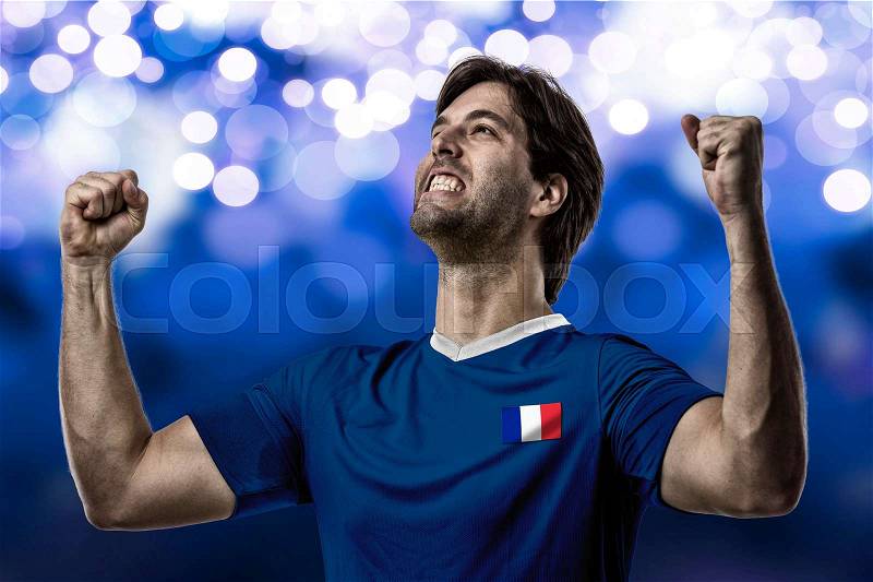 French soccer player, celebrating on a blue lights background, stock photo