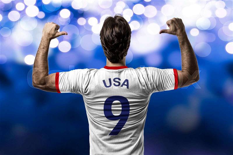 American soccer player, celebrating on a blue lights background, stock photo