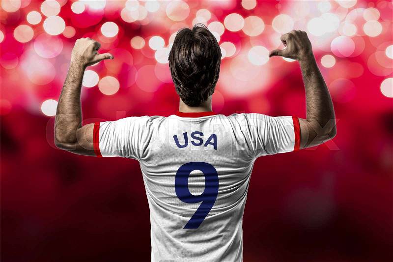 American soccer player, celebrating on a red lights background, stock photo