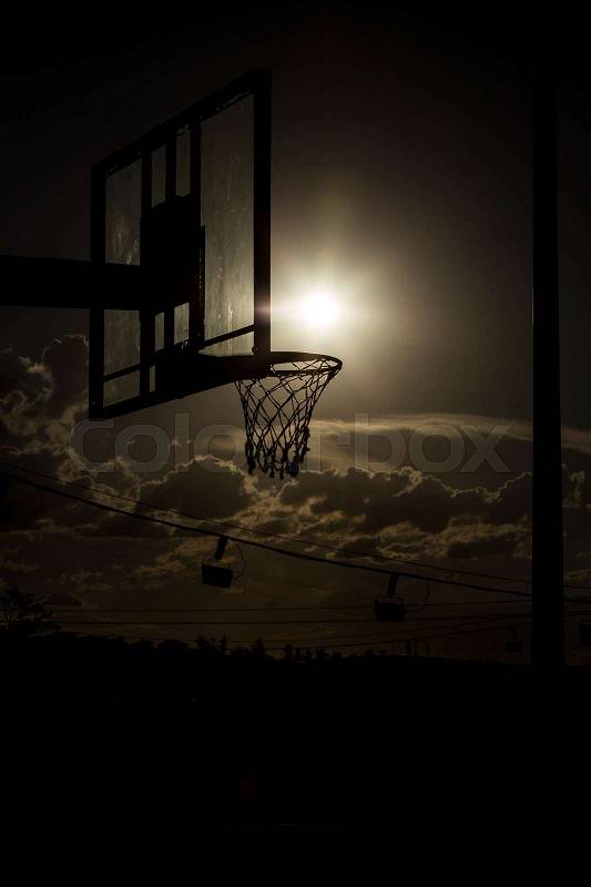 Silhouette of a basketball hoop, under the sunset, stock photo