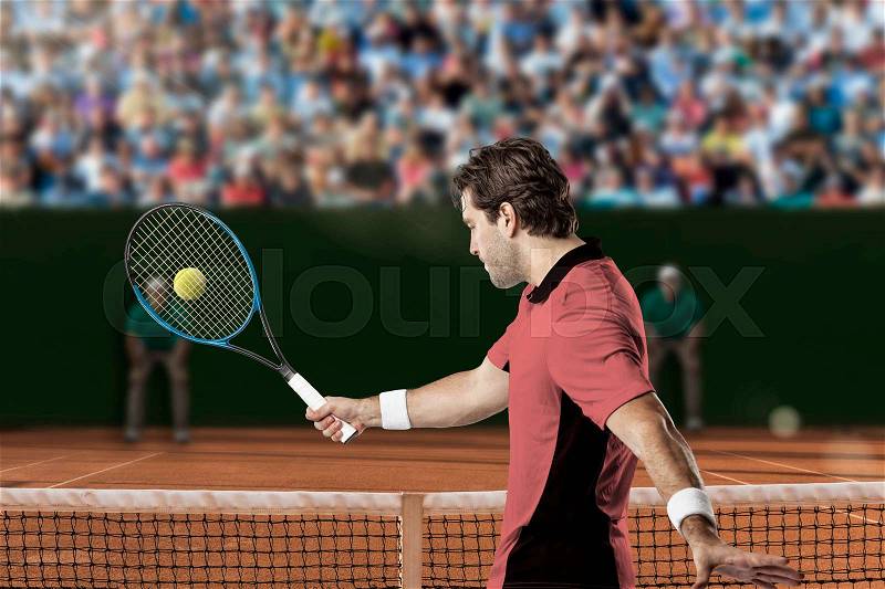 Tennis player with a pink shirt, returning a ball on a clay tennis court, stock photo