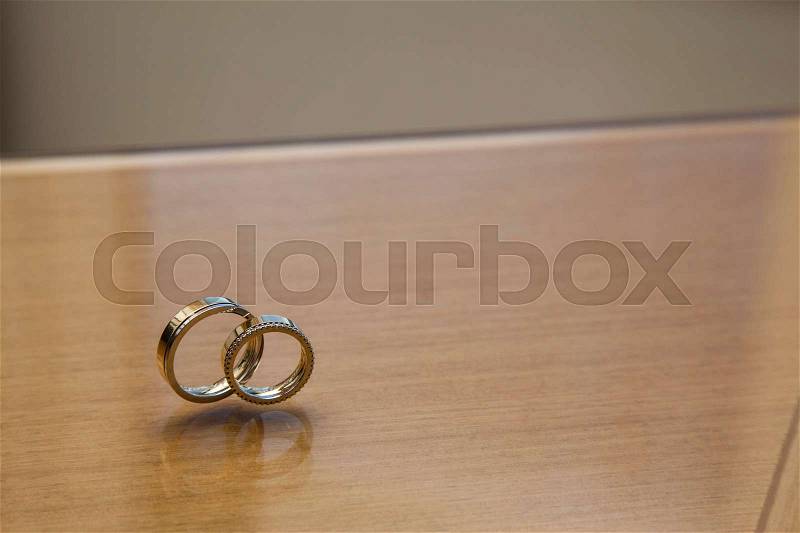 Wedding band on a wooden table, stock photo