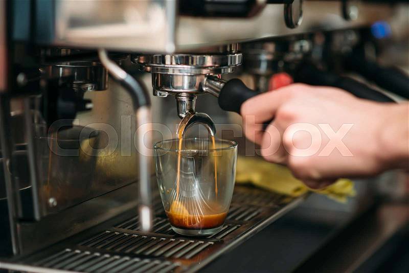 Preparation of drink in the coffee machine. Coffee house concept, stock photo