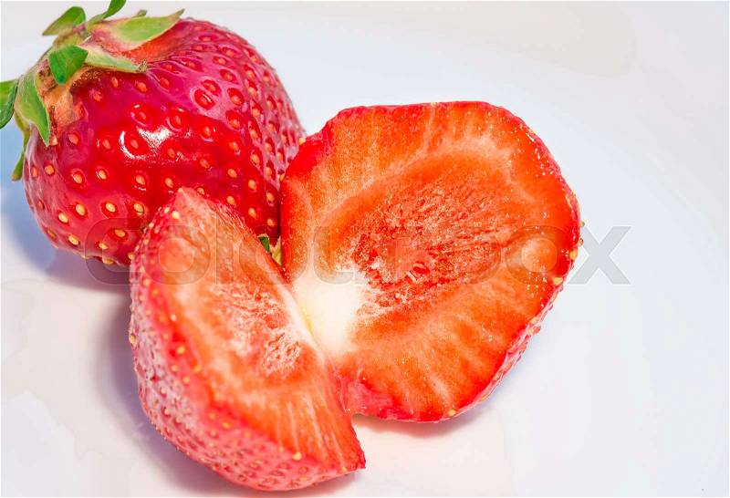 Fresh ripe red strawberries closeup on a white dish, background, stock photo