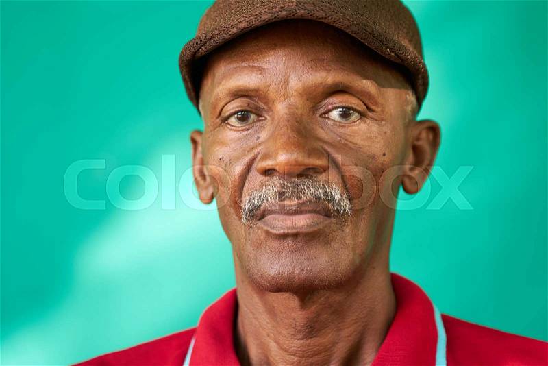 Real Cuban people and feelings, portrait of sad senior african american man looking at camera. Worried old latino grandfather with mustache and hat from Havana, Cuba, stock photo