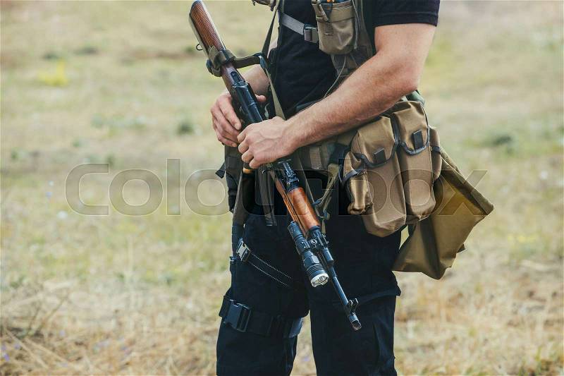 Soldier with a gun in the hands of the patrol area, stock photo