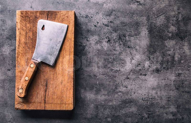 Butcher. Vintage butcher meat cleavers with cloth towel on dark concrete or wooden kitchen board, stock photo