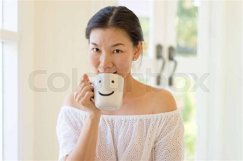 Woman hands holding a white coffee mug, stock photo