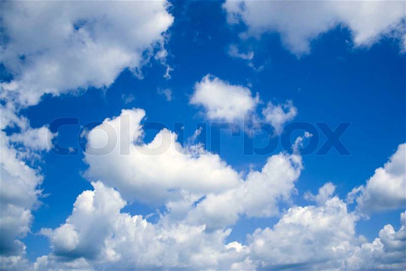 A deep blue sky and perfect cottony clouds, stock photo