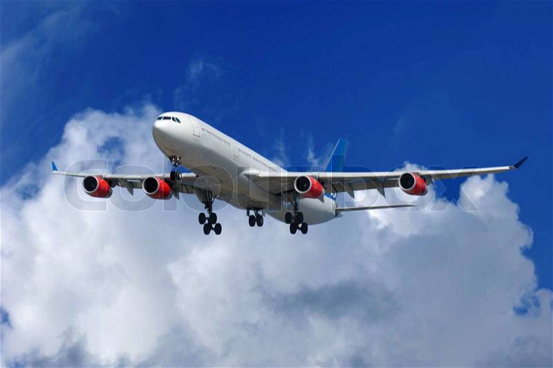Big airliner on blue and cloudy sky, stock photo