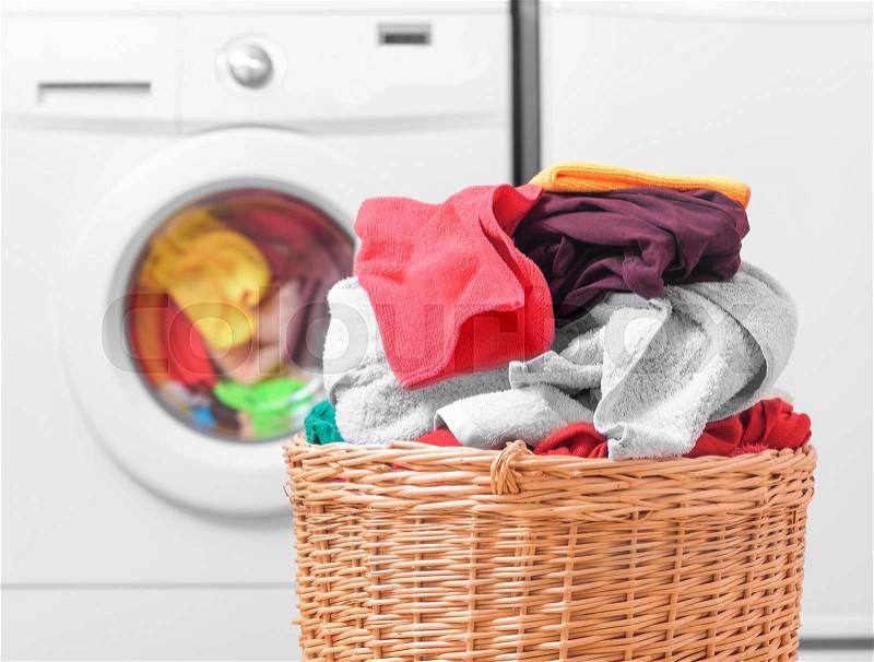 Laundry basket on the background of the washing machine, stock photo
