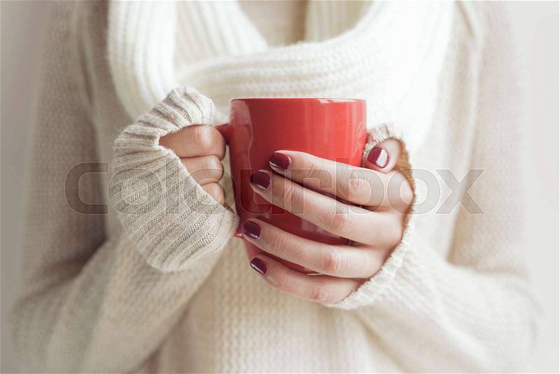 Cup of tea or coffee in female hands close up. Toned photo, stock photo
