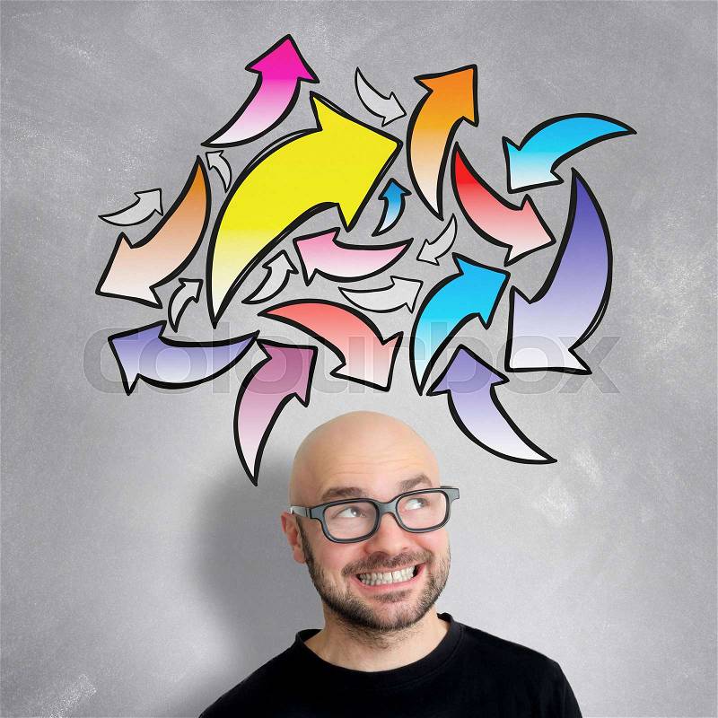 View of a Young attractive smiling geek man with brainstormaing arrow over the head, stock photo