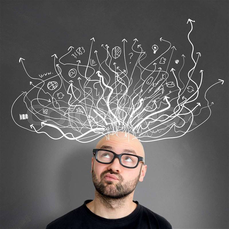 View of a Young attractive perplexed geek man with brainstormaing arrow over the head, stock photo